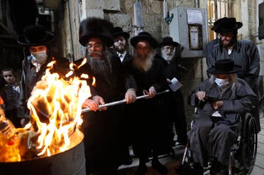 Ultra-Orthodox Jews light a Lag BaOmer bonfire in Jerusalem’s religious Mea Shearim neighborhood amid orders to cancel all Lag BaOmer holiday celebrations, on May 11, 2020, during the coronavirus pandemic. (AFP)