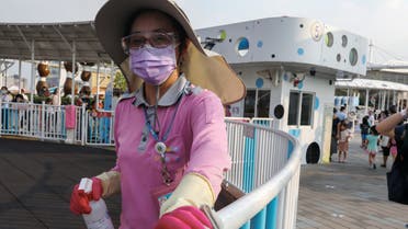 A staff worker wearing a protective face mask and gloves cleans a fence at the Taipei Children's Amusement Park, amid the outbreak of the coronavirus disease (COVID-19) in Taipei, Taiwan, May 1, 2020. REUTERS/Ann Wang