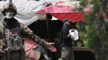 An Afghan security officer carries a baby after gunmen attacked a maternity hospital, in Kabul, Afghanistan on May 12, 2020. (AP)