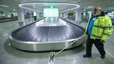 A staff member cleans the area near a baggage belt as the International airport presents additional COVID-19 safety measures, amid the coronavirus disease outbreak in Frankfurt, Germany, May 12, 2020. REUTERS/Ralph Orlowski