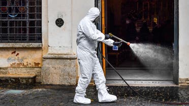 A member of the Italian Army, wearing protective overall and mask, sprays sanitizer outside of the Santuario della Madonna del Divino Amore church on May 13, 2020 in the southern Castel di Leva district of Rome, during the country's lockdown aimed at curbing the spread of the infection caused by the novel coronavirus. The Italian Army, at the specific request of the Vicariate of Rome, started on May 13, 2020 the sanitation of Rome's churches through its specialized teams in the Chemical, Biological, Radiological and Nuclear (CBRN) fields. The activity, in collaboration with the municipality of Rome, will proceed according to a specific calendar for blocks of municipalities and provide for the sanitation of over 337 parish churches.