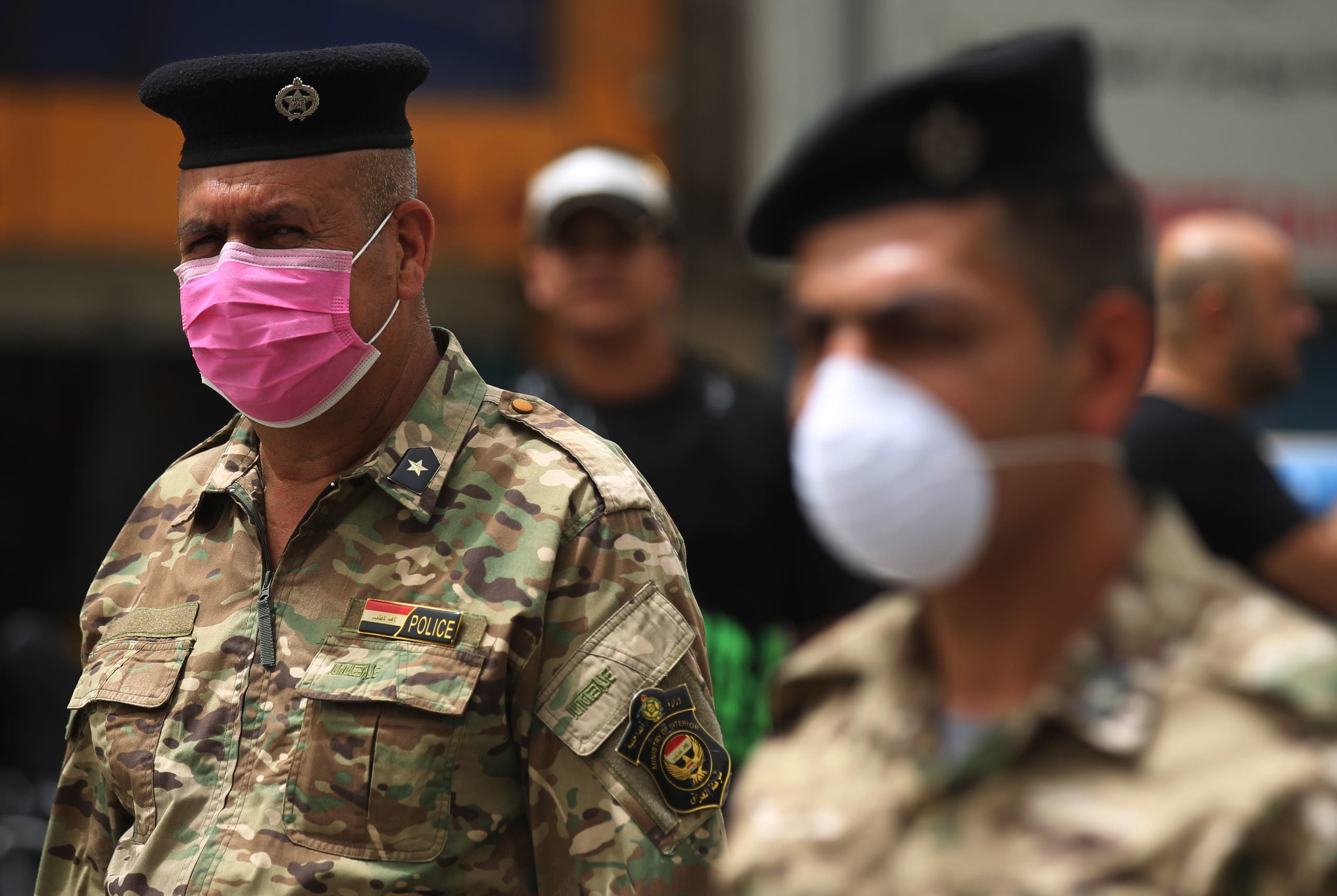 Members of the Iraqi security forces wearing protective masks keep watch at Tahrir Square in central Baghdad on May 5, 2020. (AFP)