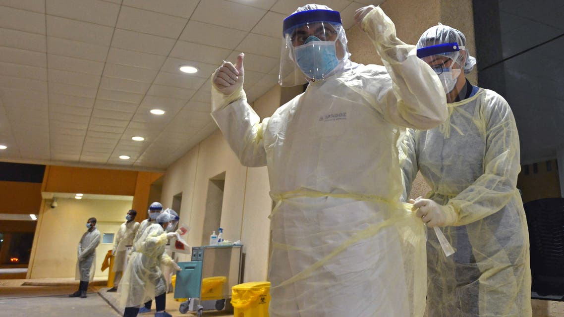 Health workers prepare to perform nose swab tests during a drive through coronavirus test campaign held in Diriyah hospital in the Saudi capital Riyadh on May 7, 2020 amid the COVID-19 pandemic. (AFP)