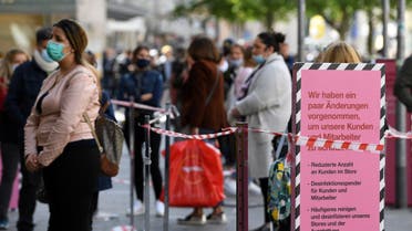 Customers wait in line after the coronavirus disease (COVID-19) lockdown has been eased around the country and companies open some of its stores, in Munich, Germany, May 12, 2020. REUTERS/Andreas Gebert