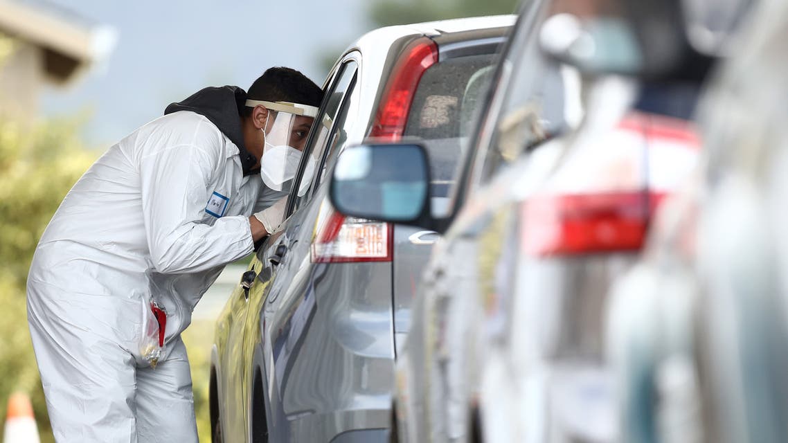 BOLINAS, CALIFORNIA - APRIL 20: A medical professional administers a coronavirus (covid-19) test at a drive thru testing location conducted by staffers from University of California, San Francisco Medical Center (UCSF) in the parking lot of the Bolinas Fire Department April 20, 2020 in Bolinas, California. The town of Bolinas, with a population of 1600, is attempting to test the entire town for COVID-19. The test had two components - the first is a blood test that will look for antibodies, and the second is a mouth and throat swab that can detect active coronavirus infections. Ezra Shaw/Getty Images/AFP