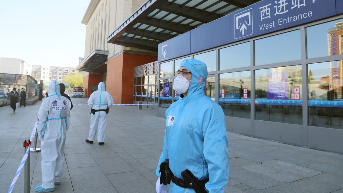 Police officers in protective suits are seen in front a closed entrance to a train station, following the outbreak of the novel coronavirus disease (COVID-19), in Jilin, Jilin province, China May 13, 2020. cnsphoto via REUTERS. ATTENTION EDITORS - THIS IMAGE WAS PROVIDED BY A THIRD PARTY. CHINA OUT.