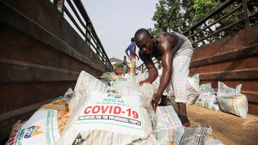 Men load sacks of rice among other food aid in a truck, to be distributed for those affected by procedures taken to curb the spread of coronavirus disease (COVID-19), in Abuja, Nigeria April 17, 2020. Picture taken April 17, 2020. REUTERS/Afolabi Sotunde