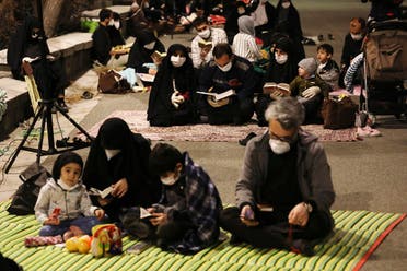 Worshippers wearing protective face masks pray outside the mosque of the Tehran University in Laylat al-Qadr, during the holy fasting month of Ramadan, Iran, May 12, 2020. (AP)