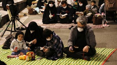 Worshippers wearing protective face masks pray outside the mosque of the Tehran University in Laylat al-Qadr, during the holy fasting month of Ramadan, Iran, May 12, 2020. (AP)