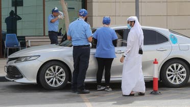 Health workers assist at a drive-thru testing service for COVID-19 coronavirus in the Qatari capital Doha, on May 7, 2020. (AFP)