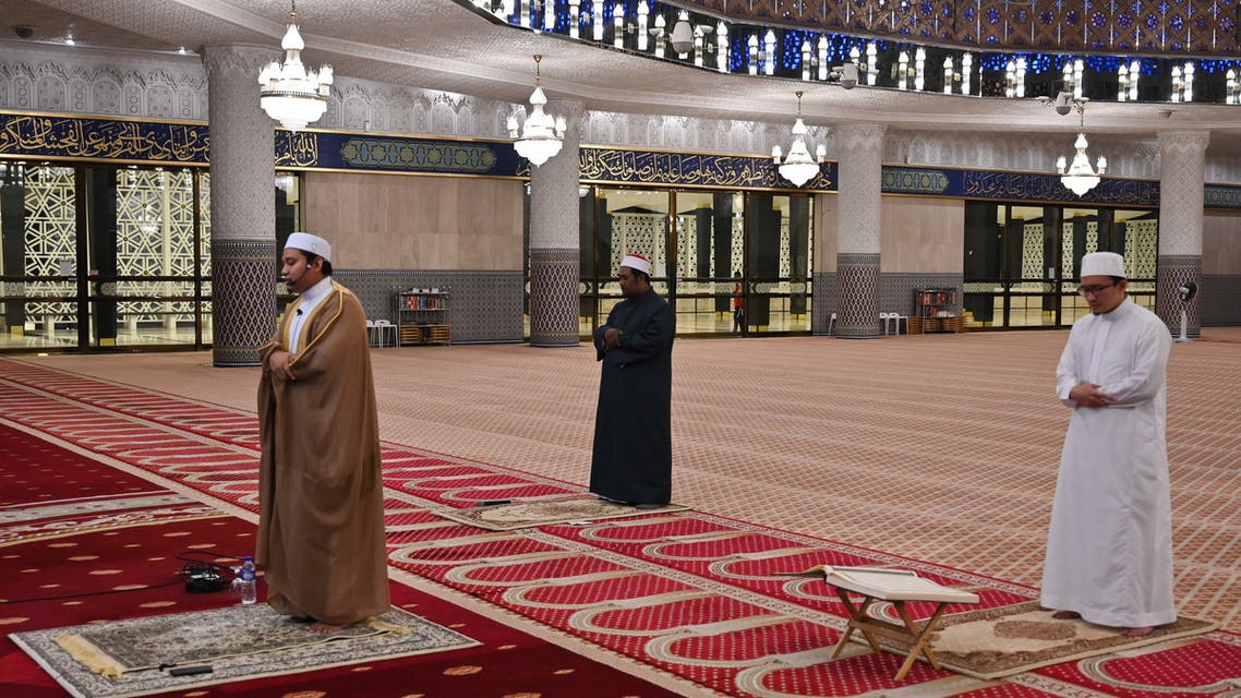 Muslim clerics practice social distancing while reciting evening prayer at the National Mosque in Kuala Lumpur on April 24, 2020. (AFP)