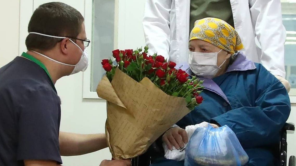 Pelageya Poyarkova, 100, wearing a protective mask poses for a picture as she leaves the hospital. (Twitter/@mfa_russia)