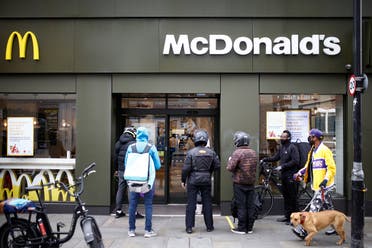 Delivery men are seen outside a reopened McDonald's with take-out only deliveries in Dalston, following the outbreak of the coronavirus disease (COVID-19), London. (Reuters)