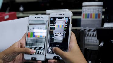 A worker conducts a color test on OPPO F1s smartphones at an OPPO smartphone factory in Tangerang, Indonesia, September 20, 2016. REUTERS
