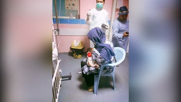 Feroza Younis Omar pictured breastfeeding a newborn baby at the Ataturk Hospital in Kabul. (Via Twitter)