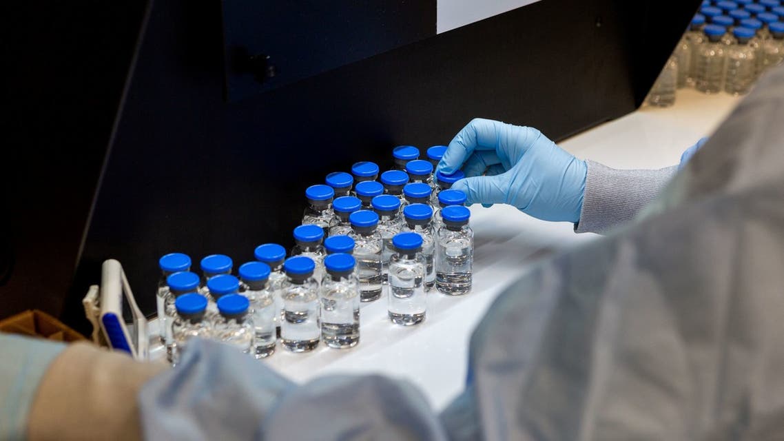 A lab technician inspects filled vials of investigational coronavirus treatment drug remdesivir at a Gilead Sciences facility in La Verne, California, US, March 11, 2020. (Reuters)