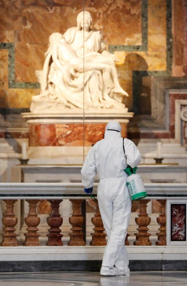 A Vatican staff member in protective gear sanitizes the interior of St. Peter's Basilica, as part of efforts to combat a spread of the coronavirus, at the Vatican, on May 15, 2020. (Reuters) 