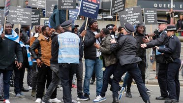 Police officers block protestors demonstrating against the government of Cameroon outside of the annual Commonwealth Day service at Westminster Abbey in London, on March 9, 2020. (File Photo: AP)