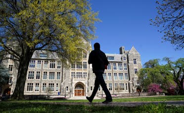A man walks at an empty campus green at Georgetown University in Washington, US, April 3, 2020. (Reuters)