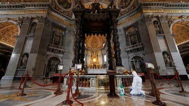 A Vatican staff member in protective gear sanitizes the interior of St. Peter's Basilica, as part of efforts to combat a spread of the coronavirus, at the Vatican, on May 15, 2020. (Reuters) 