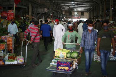 People wear protective face masks following the outbreak of the coronavirus, as they shop at a vegetable market in Manama, Bahrain, April 23, 2020. (Reuters)