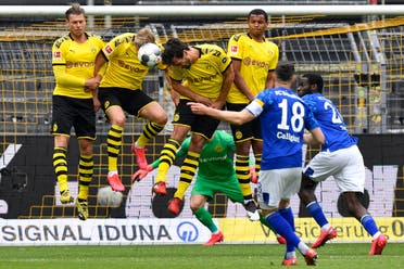 Schalke's Daniel Caligiuri, foreground, has his free kick blocked during the German Bundesliga football match between Borussia Dortmund and Schalke 04 in Dortmund, Germany, on Saturday, May 16, 2020. (AP)