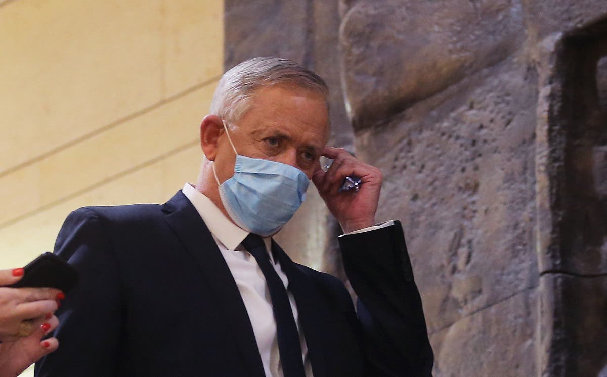 Blue and White party leader Benny Gantz, wearing a protective face mask, arrives for the swearing-in ceremony at Israel's parliament, the Knesset, in Jerusalem, on May 17, 2020. (AFP)