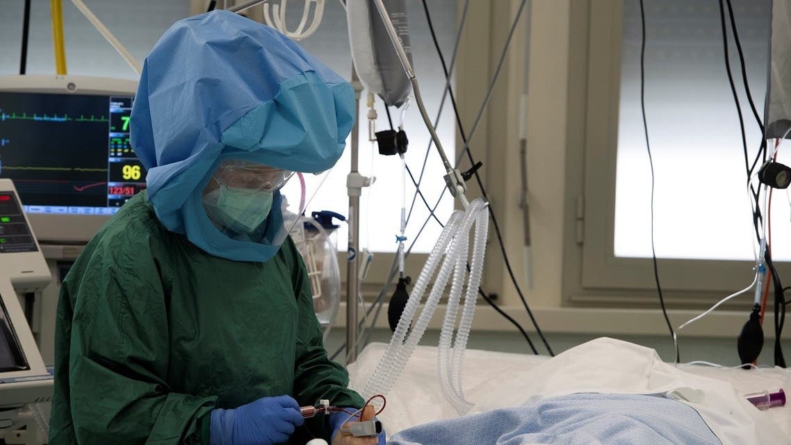A health worker wearing protective gear takes care of a patient at the intensive care unit, treating COVID-19 patients, of the Tor vergata hospital in Rome, on May 12, 2020. (AFP)