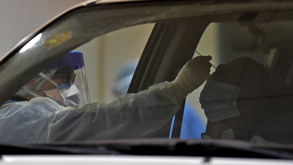 Health workers perform a nose swab test during a drive through coronavirus test campaign held in Diriyah hospital in the Saudi capital Riyadh on May 7, 2020. (AFP)
