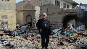 Father John Botros Moshi, the Syriac Catholic Archbishop of Mosul, Kirkuk, and the Kurdistan Region, stands in the rubbles of the Tahra church in Mosul on April 29, 2018. (File photo: AFP)