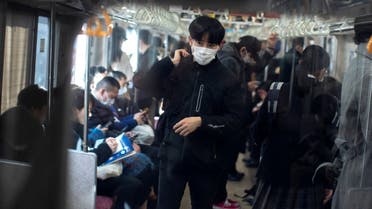 A man wearing a protective face mask travels by train in Tokyo, Japan, February 17, 2020. (Reuters)