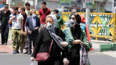 Iranian women wearing protective masks amid the novel coronavirus pandemic, cross a street in the capital Tehran, on May 09, 2020. (AFP)