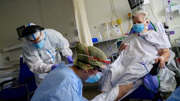 Two physiotherapists attend to a patient who recovered from COVID-19 at the Gregorio Maranon University Hospital in Madrid on May 14, 2020. One of the world's worst-hit countries in which the virus has killed nearly 27,000 people, Spain has begun a cautious process of slowly lifting its stringent mid-March lockdown.