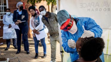 Doctors Without Borders (MSF) nurse Bhelekazi Mdlalose (2nd R) performs a swab test for COVID-19 coronavirus on a health worker at the Vlakfontein Clinic in Lenasia, Johannesburg, on May 13, 2020. (AFP)