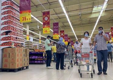 People wearing protective face masks push shopping trollies inside a Carrefour hypermarket, amid concerns over the coronavirus disease (COVID-19), in the Cairo suburb of Maadi, Egypt on May 15, 2020. (Reuters) 