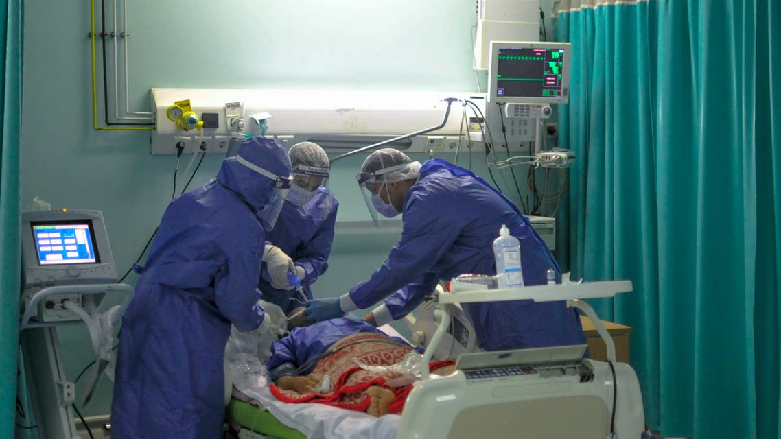 A picture taken by a doctor at the Sheikh Zayed hospital in the Egyptian capital Cairo on April 25, 2020, shows members of a medical staff, wearing protective gear, intubating a patient in the isolated ward for the coronavirus (COVID-19) patients. The virus has so far infected over 8,000 people and claimed 514 lives in Egypt, according to official figures.
