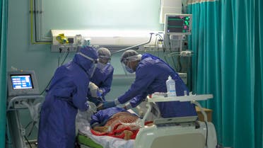 A picture taken by a doctor at the Sheikh Zayed hospital in the Egyptian capital Cairo on April 25, 2020, shows members of a medical staff, wearing protective gear, intubating a patient in the isolated ward for the coronavirus (COVID-19) patients. The virus has so far infected over 8,000 people and claimed 514 lives in Egypt, according to official figures.