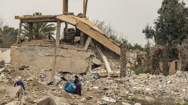 Women salvage items from the rubble of a destroyed house in the eastern Syrian village of Baghouz on March 13, 2020, a year after the fall of the ISIS. (File Photo: AFP)