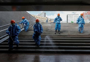 Specialists wearing protective gear spray disinfectant while sanitizing an underground passage amid the outbreak of the coronavirus disease (COVID-19) in Moscow, Russia May 16, 2020. (Reuters)