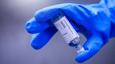 Hand holds Coronavirus Covid-19 Vaccine glass bottle stock photo