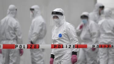 Members of a coronavirus testing station stand on the factory premises of the Westfleisch meat processing company in Hamm, western Germany, on May 10, 2020, as all workers of the company have to be tested on the novel coronavirus after a spike in cases at their slaughterhouse. Local authorities in the western federal state of North Rhine-Westphalia announced on May 8, 2020 that reopening plans were postponed and an emergency mechanism would come into effect due to high infection rates in the region. Many of the Westfleisch company's workers, partially originating from Eastern Europe and housed in shared accomodation, were tested positive on the novel coronavirus that can cause the COVID-19 disease.