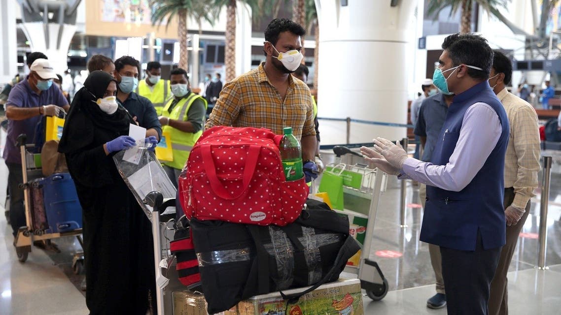 Indian nationals check in at the Muscat International Airport before leaving the Omani capital on a flight to return to their country, on May 9, 2020. (AFP)
