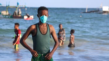 A man wears a mask as a protective measure to curb the Covid-19 coronavirus while bathing at Lido beach in Mogadishu, Somalia, on April 4, 2020. (AFP)