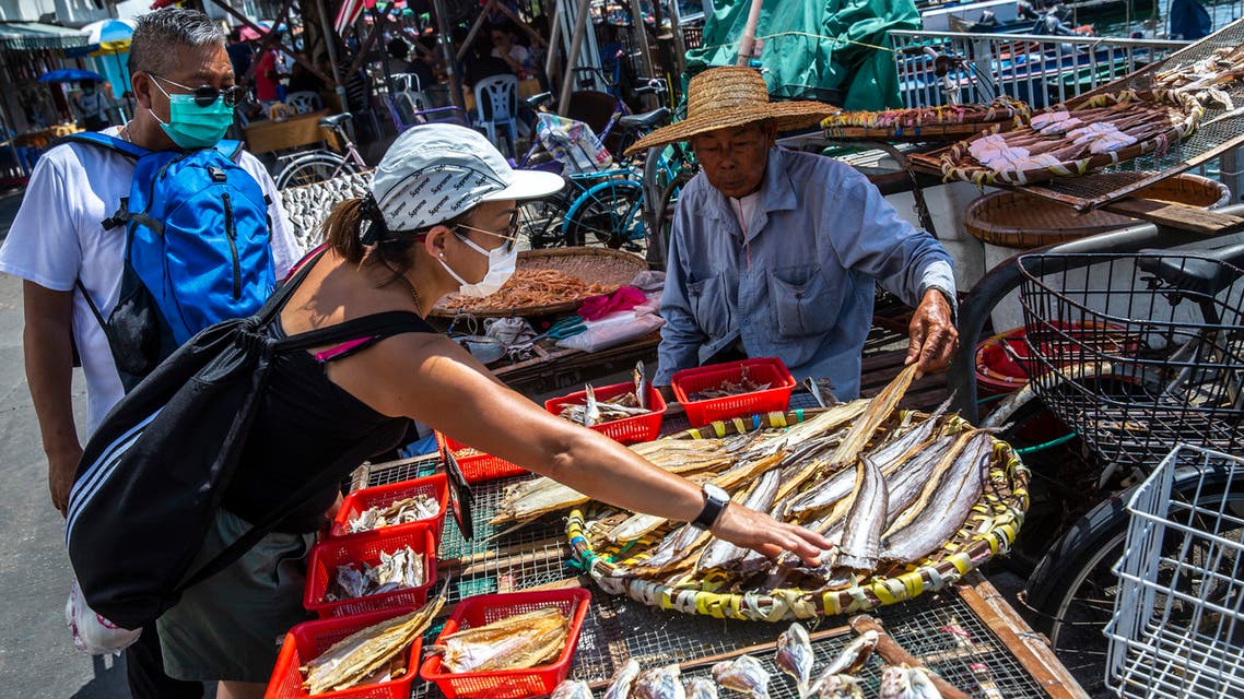 A man (R) sells dried seafood on Cheung Chau Island in Hong Kong on May 3, 2020. (AFP)