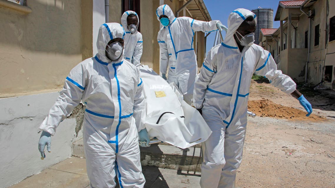 Medical workers in protective suits carry the body of a man who died of COVID-19, before he is buried in Mogadishu, Somalia on May, 13, 2020. (AP)