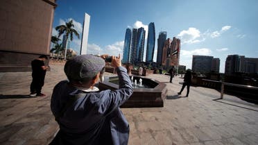 A tourist takes photos of Emirates Towers from the Emirates Palace Hotel in Abu Dhabi, United Arab Emirates, December 23, 2018. (Reuters)