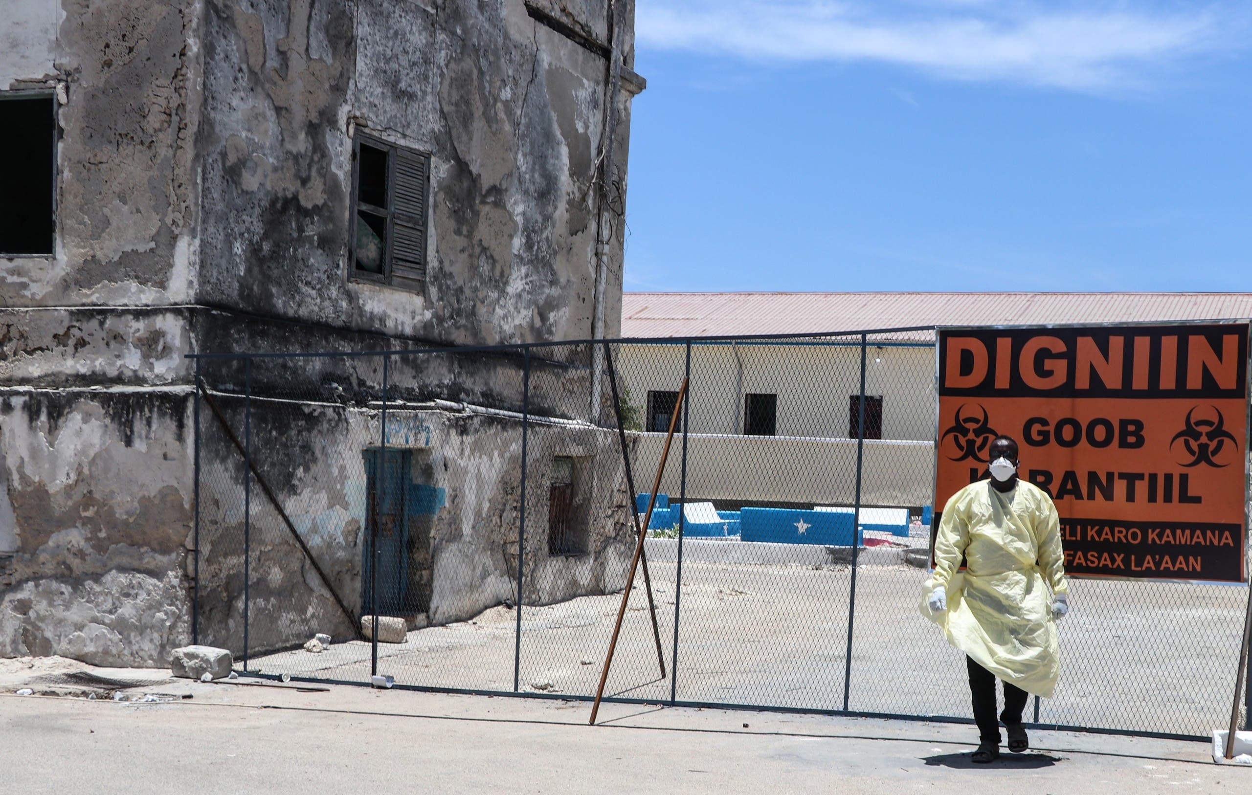 An ambulance driver wearing protective gears walks near the isolation unit for COVID-19 patients at Martini hospital in Mogadishu on March 29, 2020. (AFP)