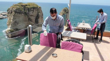 Waiters fix chairs at a restaurant overlooking the Pigeons Rock, as Lebanon begins to ease nationwide lockdown due to spread of the coronavirus disease (COVID-19) in Beirut, Lebanon May 4, 2020. (Reuters)