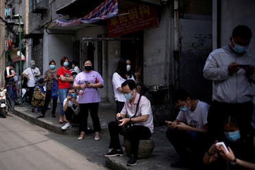Residents wearing face masks line up for nucleic acid testings at a residential compound in Wuhan, the Chinese city hit hardest by the coronavirus disease (COVID-19) outbreak, Hubei province, China May 17, 2020. (Reuters)