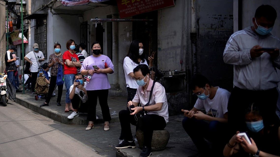 Residents wearing face masks line up for nucleic acid testings at a residential compound in Wuhan, the Chinese city hit hardest by the coronavirus disease (COVID-19) outbreak, Hubei province, China May 17, 2020. (Reuters)